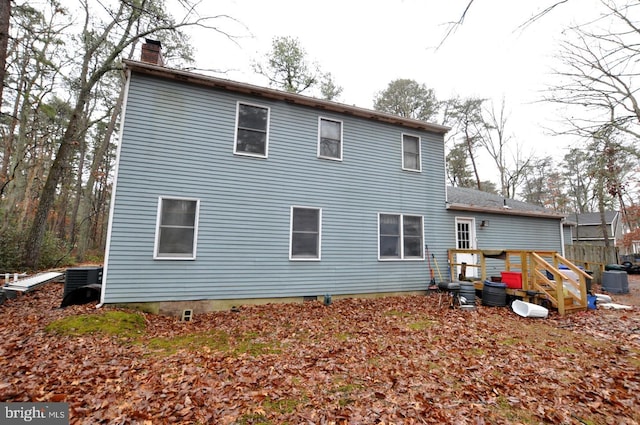 back of house with central AC unit