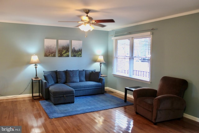 living room with hardwood / wood-style flooring, crown molding, and ceiling fan