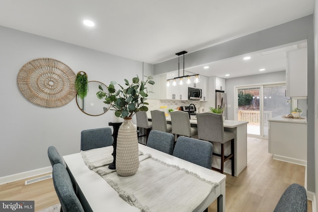 dining space with light hardwood / wood-style floors