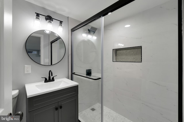 bathroom featuring vanity, toilet, and walk in shower