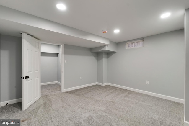 basement featuring light carpet