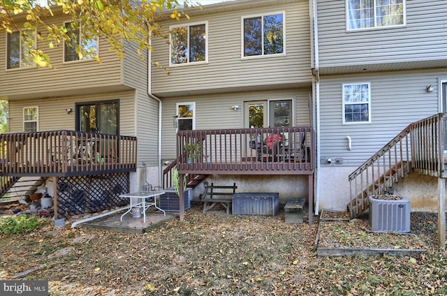 rear view of property with central AC and a deck