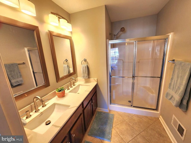 bathroom featuring an enclosed shower, vanity, and tile patterned floors