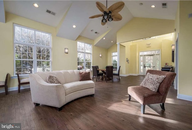 living room with dark wood-type flooring, high vaulted ceiling, french doors, and ceiling fan