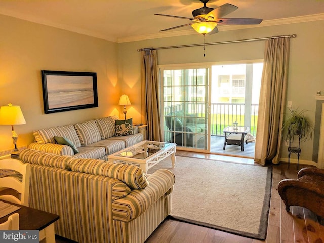 living room featuring hardwood / wood-style flooring, ornamental molding, and ceiling fan