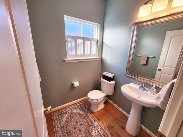 bathroom featuring hardwood / wood-style flooring and toilet