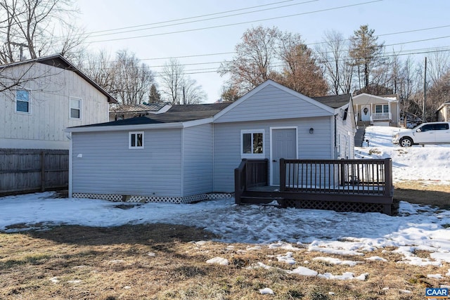 snow covered property featuring a deck