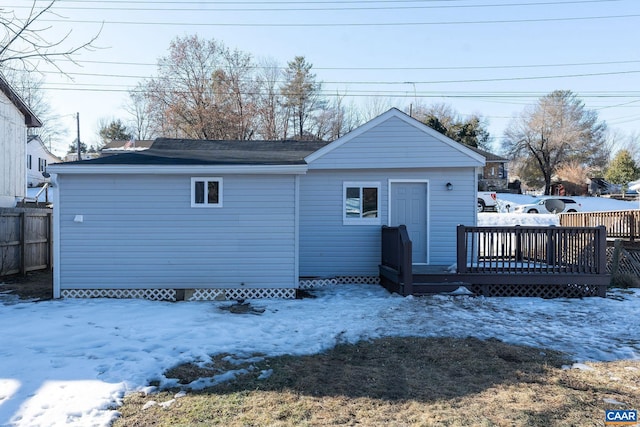 snow covered house featuring a deck