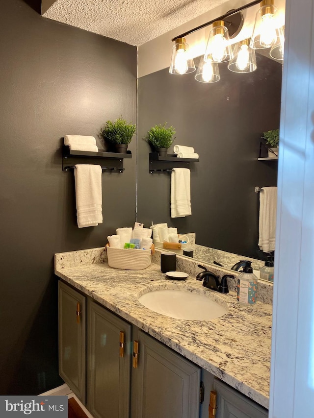 bathroom with vanity and a textured ceiling