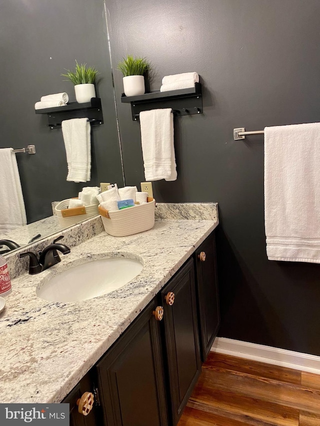 bathroom with vanity and hardwood / wood-style floors