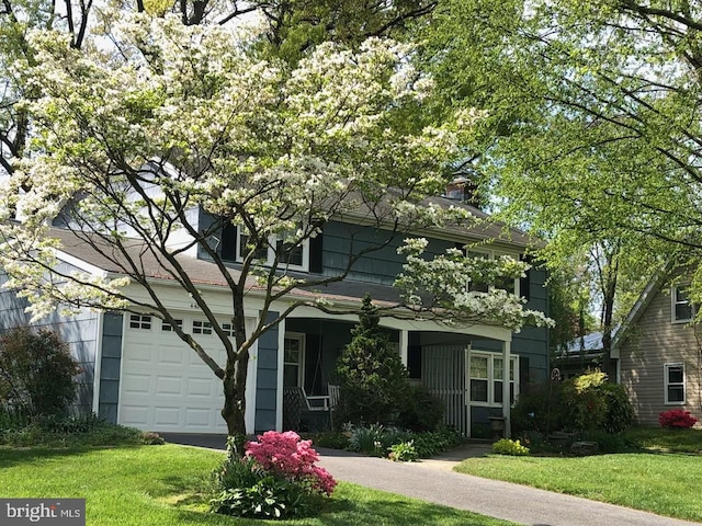 view of front of house with a garage and a front yard