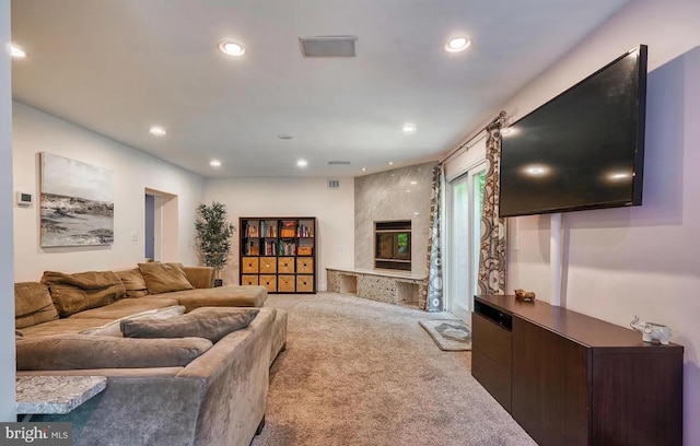 living room with light carpet and a high end fireplace