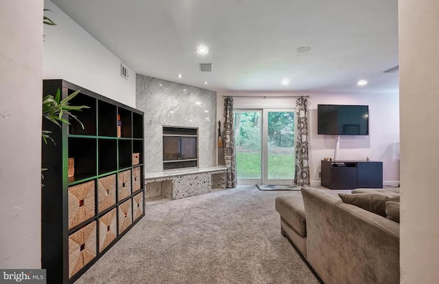 living room featuring carpet flooring and a fireplace