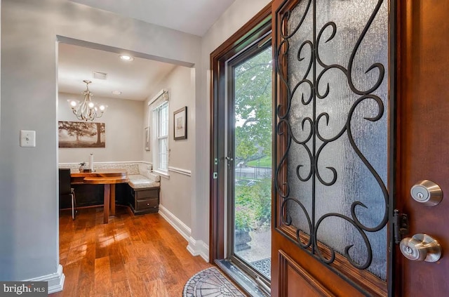 foyer entrance with a chandelier and hardwood / wood-style floors