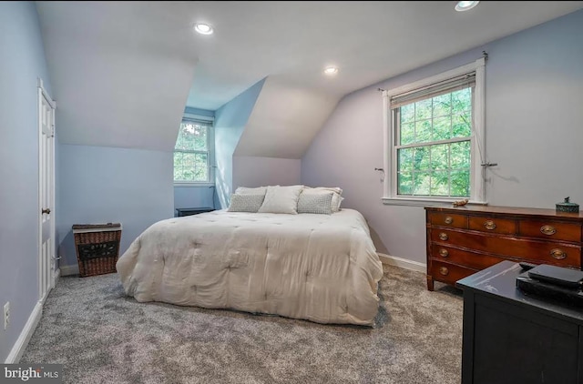 bedroom with lofted ceiling and light carpet