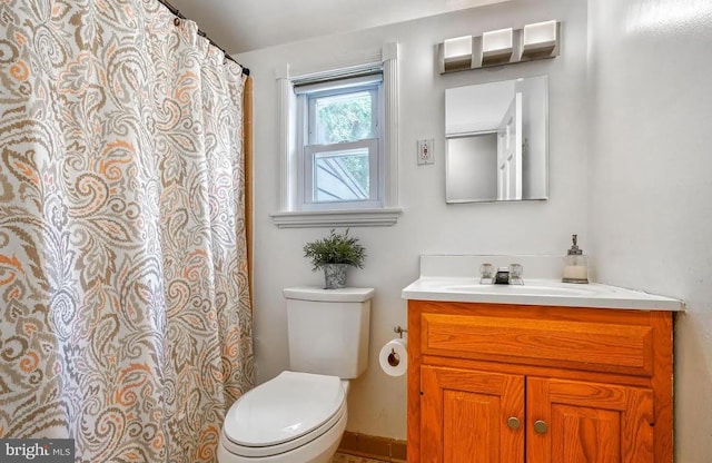 bathroom featuring vanity and toilet