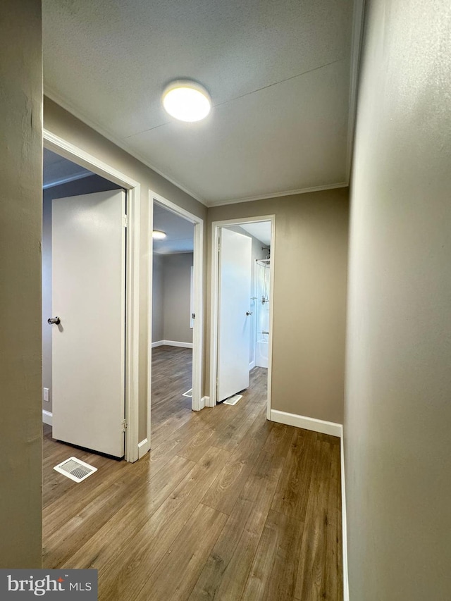 hallway with light hardwood / wood-style floors