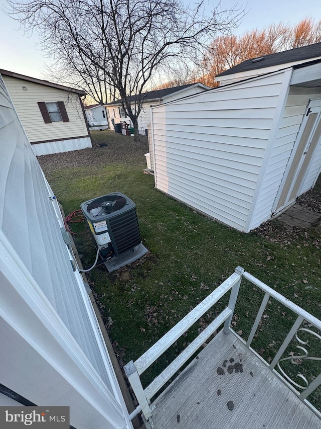 view of yard featuring central AC and a wooden deck