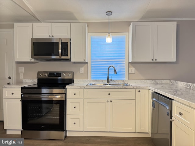 kitchen featuring stainless steel appliances, hanging light fixtures, sink, and white cabinets