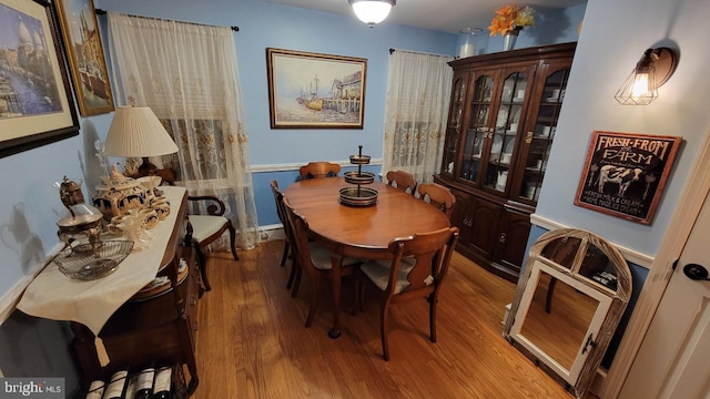 dining room with heating unit and wood-type flooring