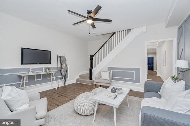 living room featuring hardwood / wood-style flooring and ceiling fan