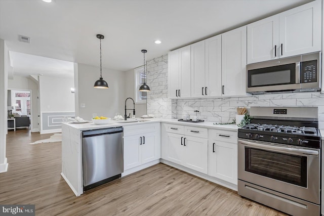 kitchen with white cabinetry, appliances with stainless steel finishes, and sink