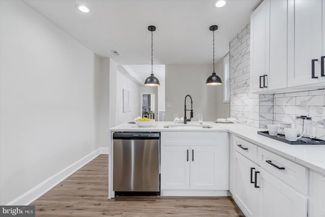 kitchen with dishwasher, sink, and white cabinets