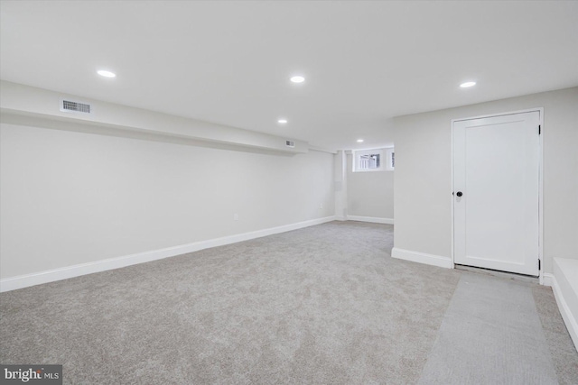 basement featuring light carpet