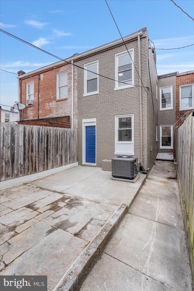 back of house with a patio area and central air condition unit