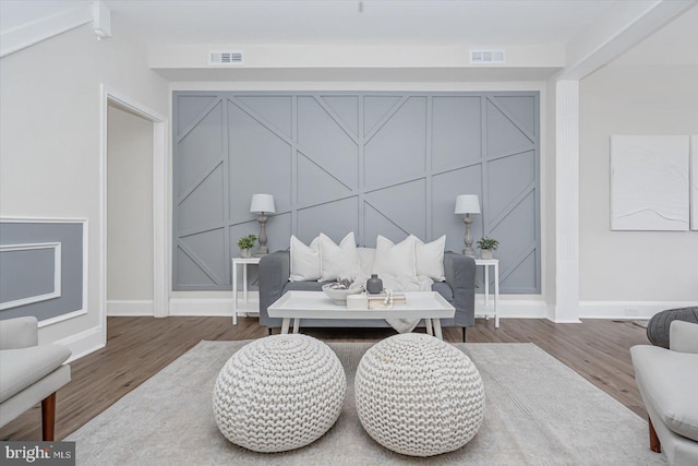 sitting room with wood-type flooring