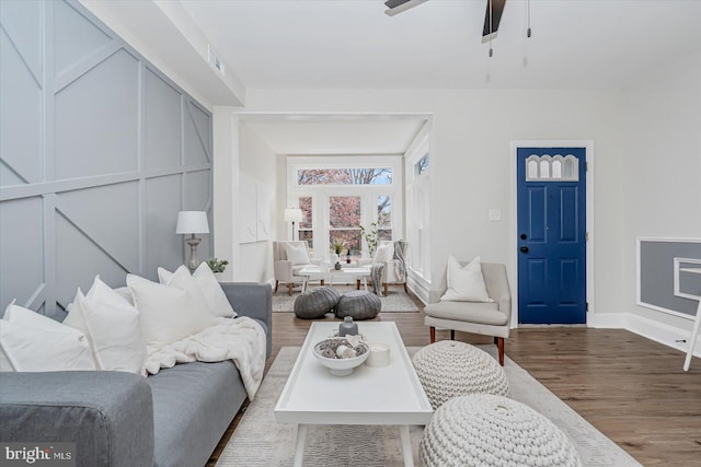 living room featuring ceiling fan and hardwood / wood-style floors