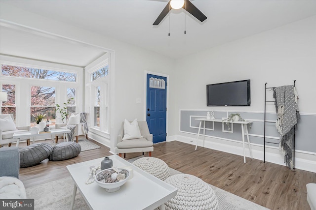 living room with ceiling fan and hardwood / wood-style floors