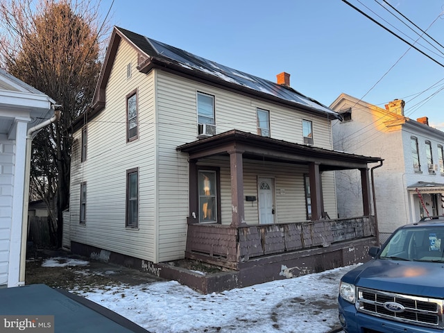 view of front of property featuring cooling unit and covered porch