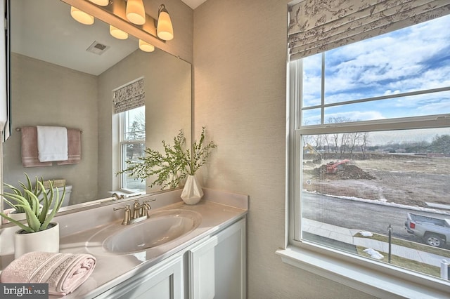 bathroom with vanity and vaulted ceiling