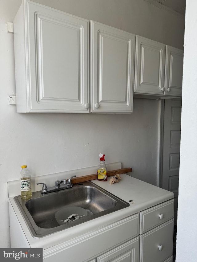 kitchen with white cabinetry and sink