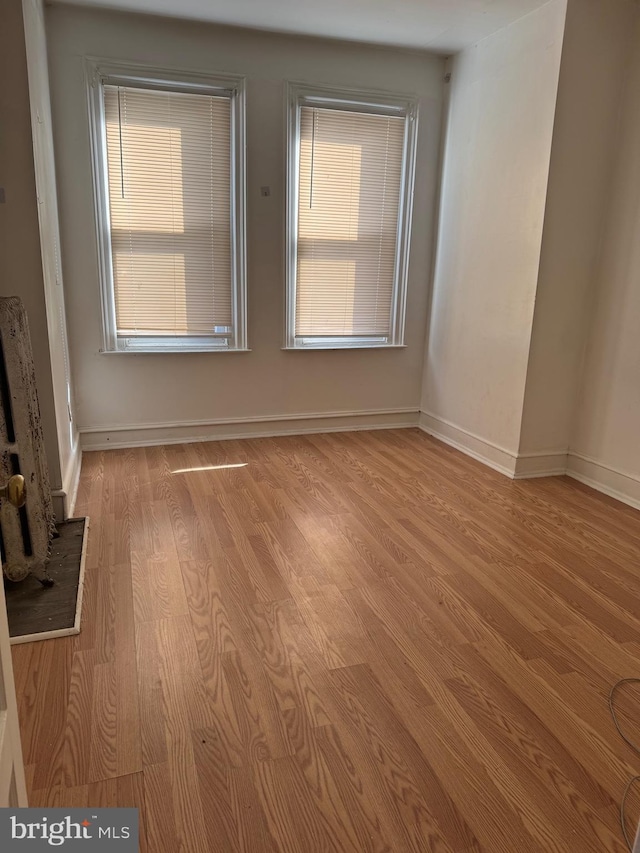 spare room with light hardwood / wood-style flooring