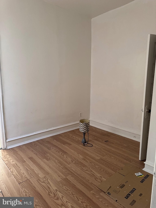 unfurnished room featuring hardwood / wood-style flooring