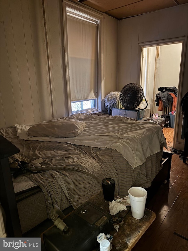 bedroom with dark hardwood / wood-style flooring