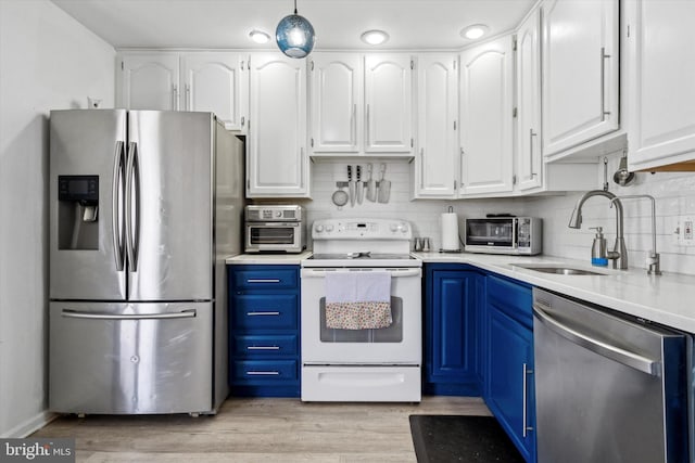 kitchen with blue cabinetry, light hardwood / wood-style flooring, sink, appliances with stainless steel finishes, and white cabinets