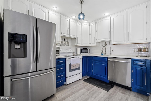 kitchen featuring white cabinetry, light wood-type flooring, stainless steel appliances, blue cabinets, and backsplash