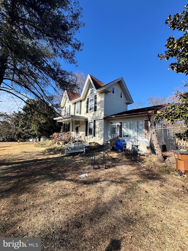 back of house featuring a yard and a pergola