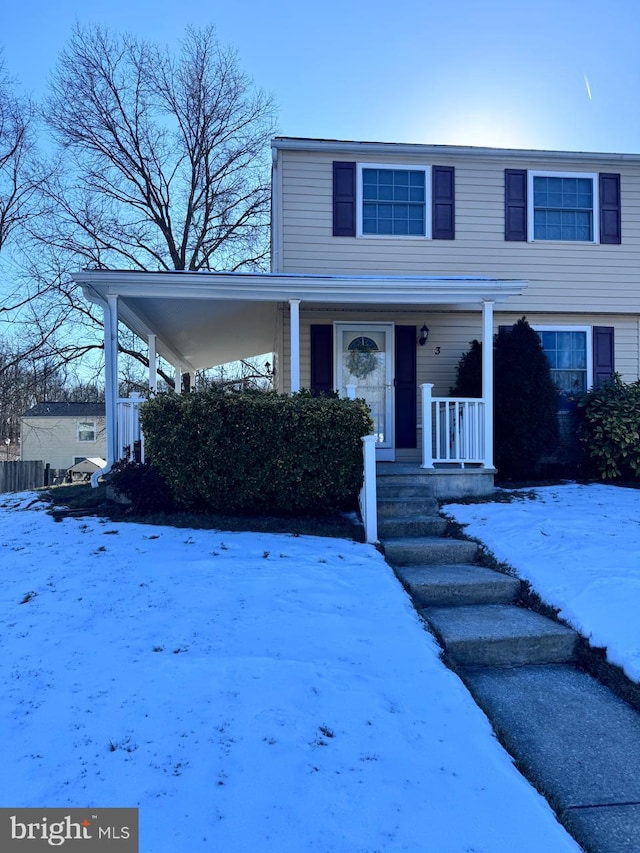 view of front of home with a carport and covered porch