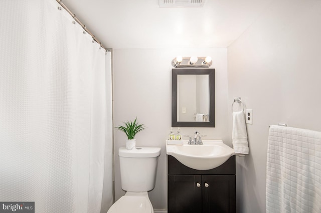 full bath featuring toilet, visible vents, and vanity