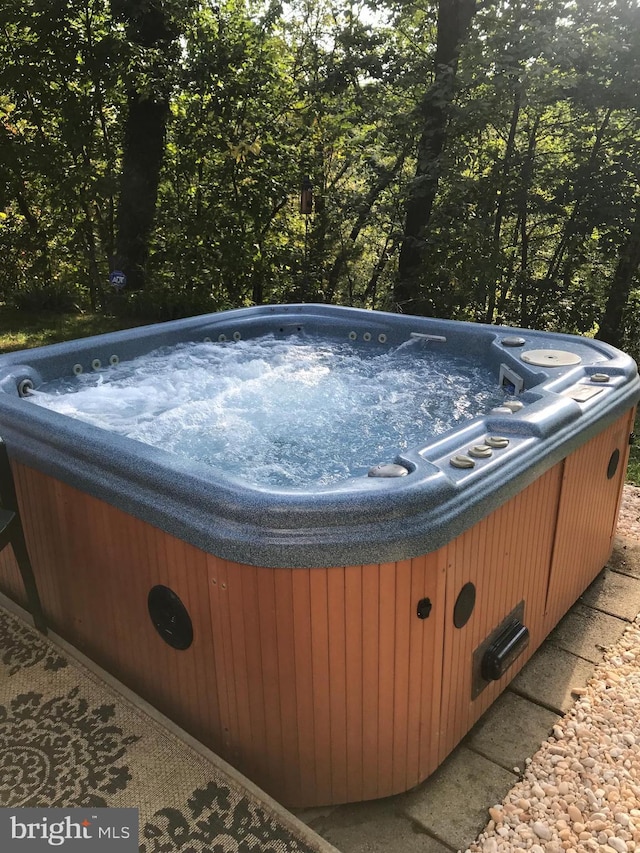 view of swimming pool featuring a hot tub