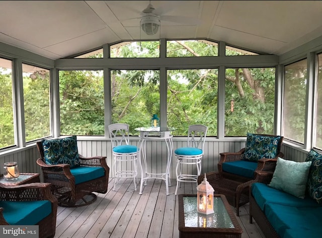 sunroom with ceiling fan and lofted ceiling