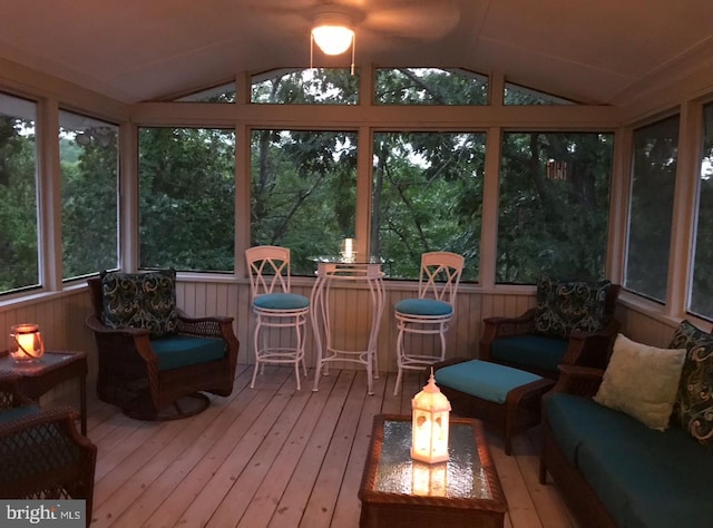 sunroom / solarium featuring vaulted ceiling