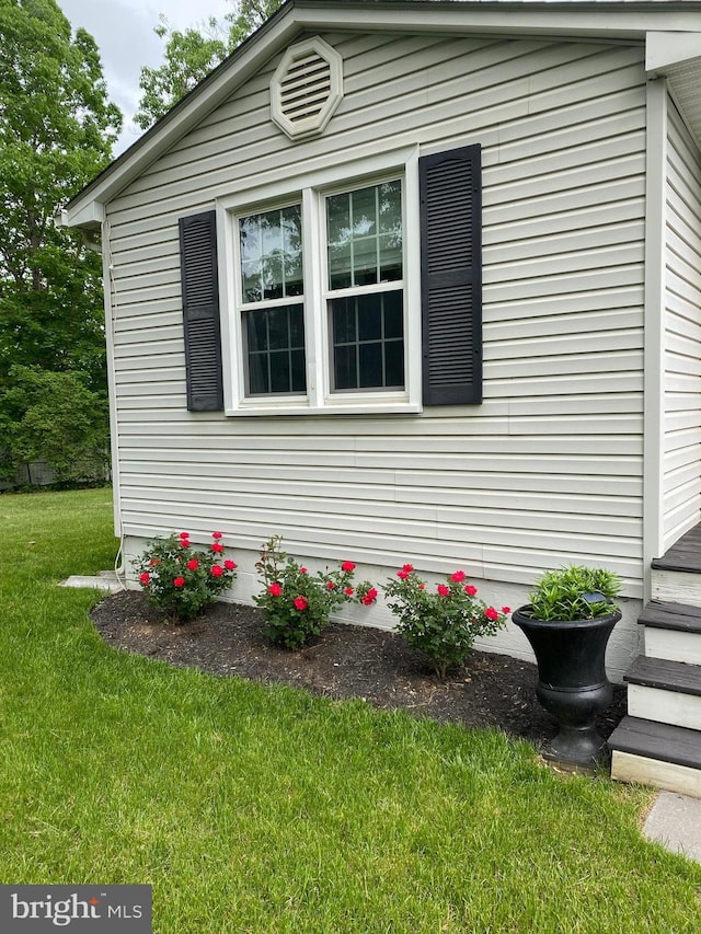 view of side of home with a lawn