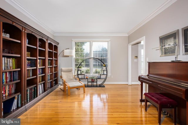 living area featuring ornamental molding and light hardwood / wood-style flooring