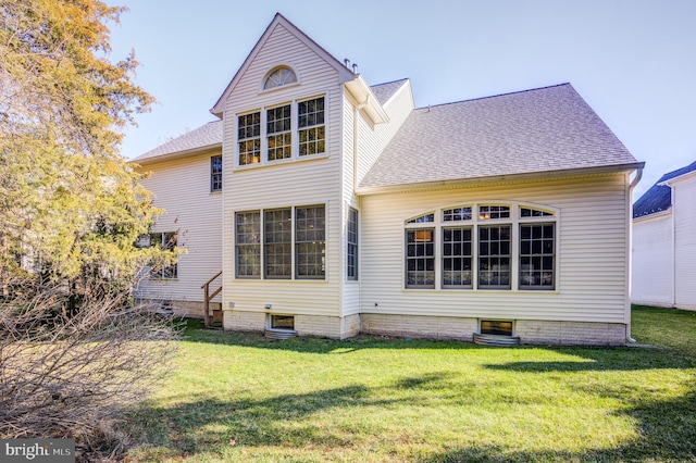 back of house with a lawn