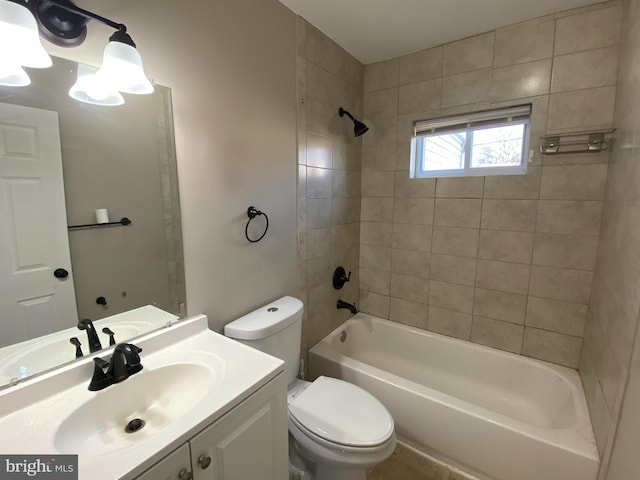 full bathroom featuring tiled shower / bath combo, vanity, and toilet